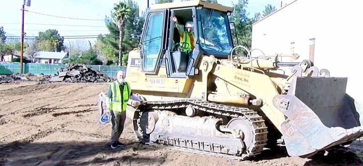 Nelda Stuck drives skip loader.